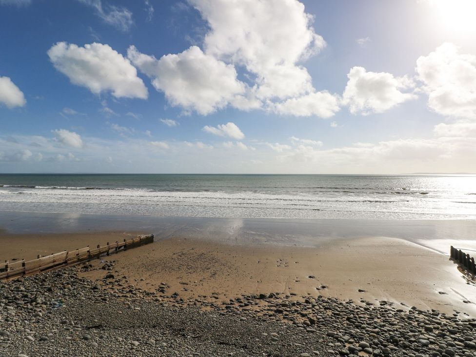 A beach with sand and ocean waves at Cuddfan in Narberth