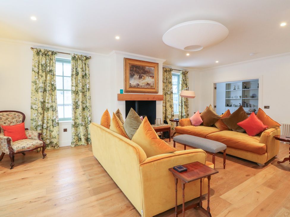 A living room with a sofa and armchair at Schiehallion House in Pitlochry