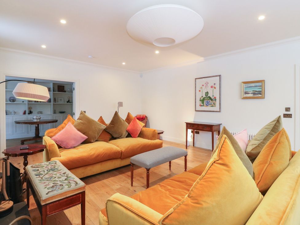 A living room with sofas and a table at Schiehallion House in Pitlochry