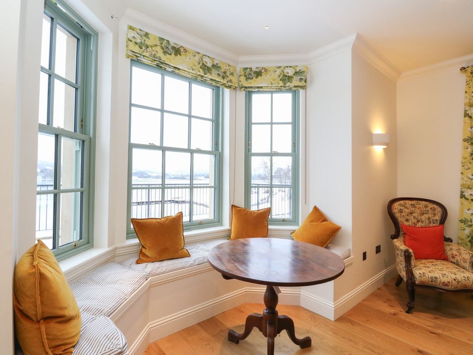 A snug area with windows and a table at Schiehallion House in Pitlochry