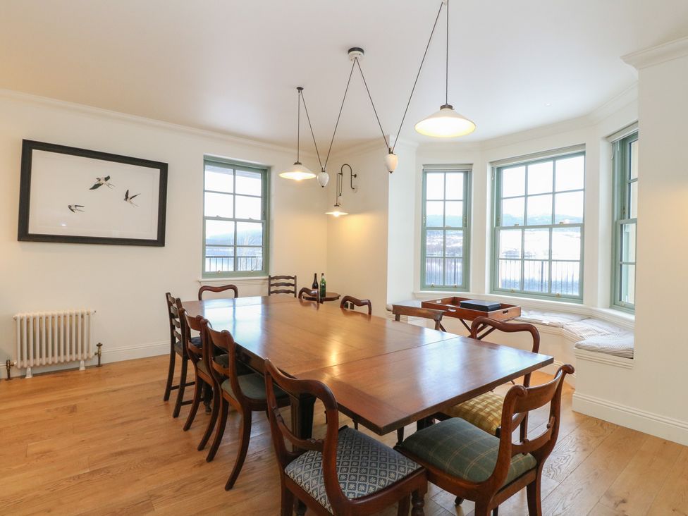 A dining room with a table and chairs at Schiehallion House in Pitlochry