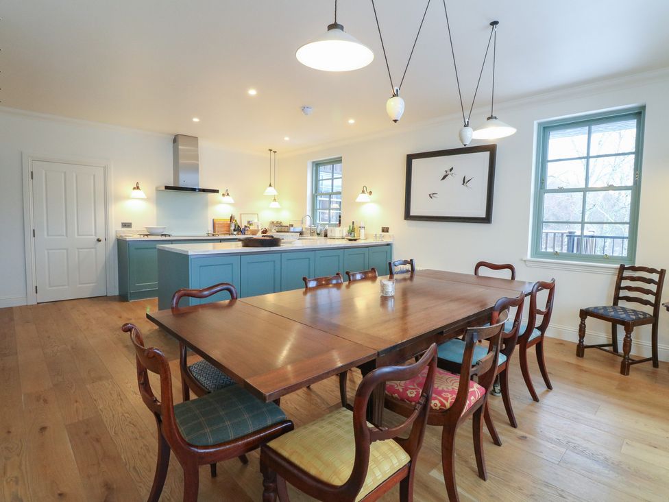 A kitchen with a dining table and chairs at Schiehallion House in Pitlochry