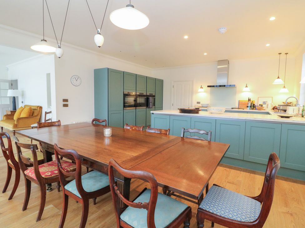 A kitchen with a dining table and chairs at Schiehallion House in Pitlochry