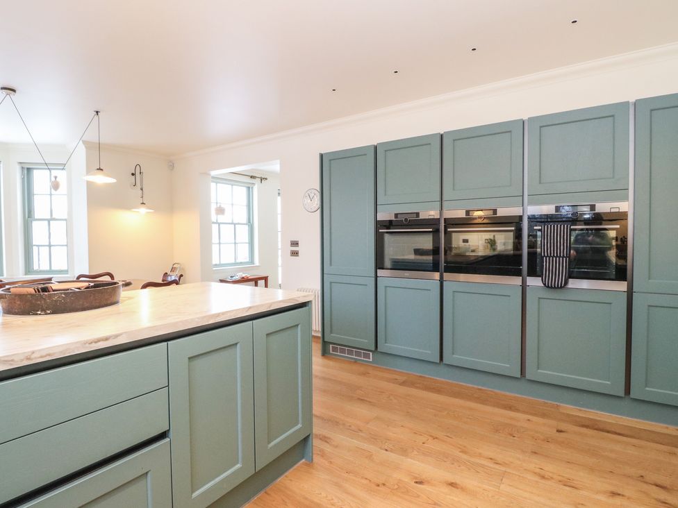A kitchen with a kitchen island and built-in ovens at Schiehallion House in Pitlochry