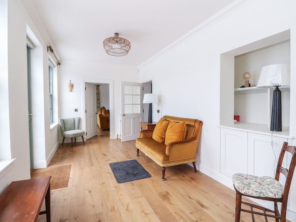 A living room with a sofa and armchair at Schiehallion House in Pitlochry