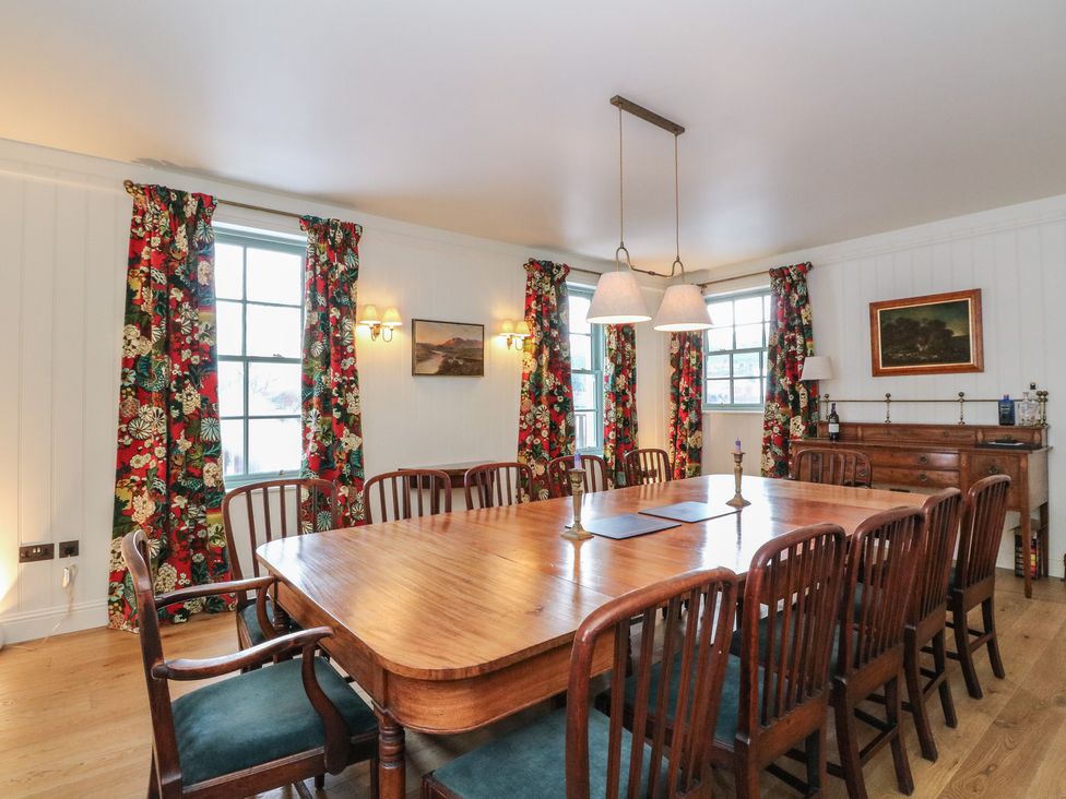 A dining room with a large table and chairs at Schiehallion House in Pitlochry