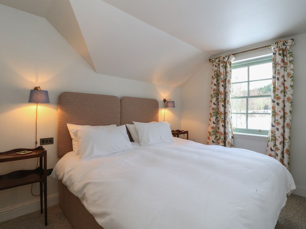 A bedroom with a bed and window at Schiehallion House in Pitlochry