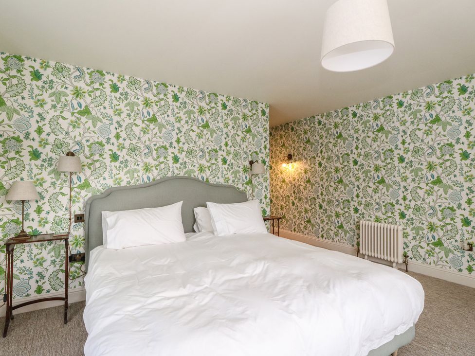 A bedroom with a bed and bedside tables at Schiehallion House in Pitlochry