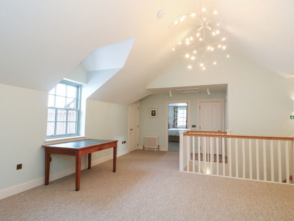 A landing area with a table and window at Schiehallion House in Pitlochry
