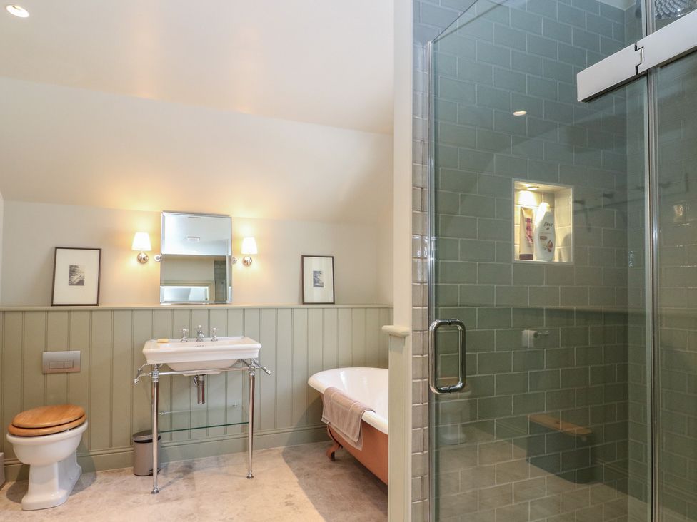 A bathroom with a bathtub and shower at Schiehallion House in Pitlochry