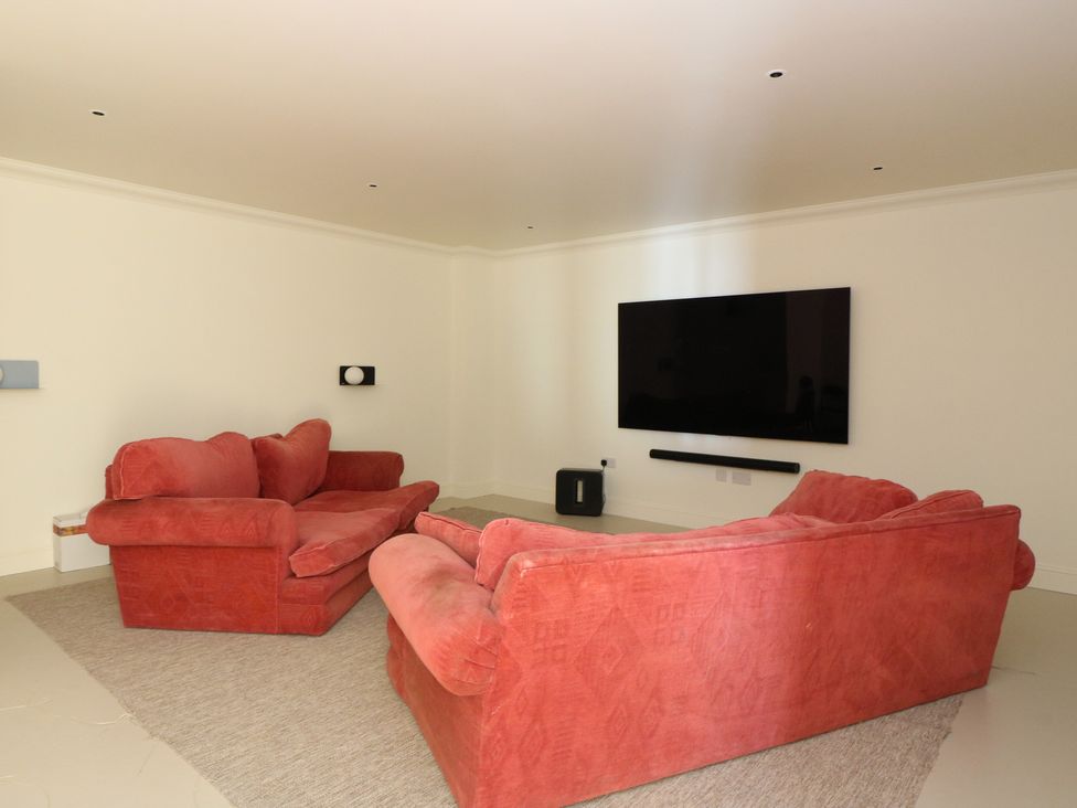 A living room with a sofa and television at Schiehallion House Pitlochry