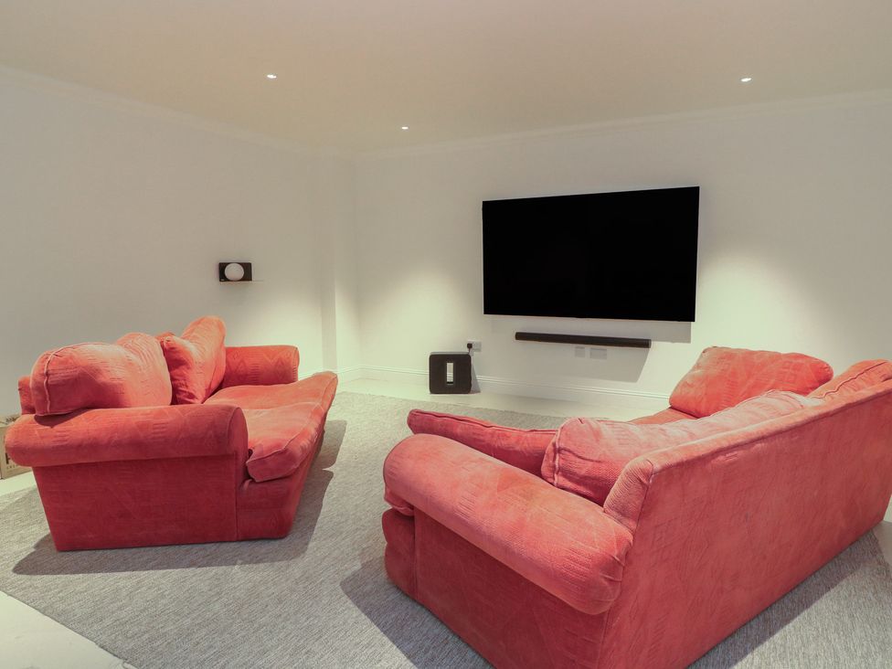 A living room with two sofas and a television at Schiehallion House Pitlochry