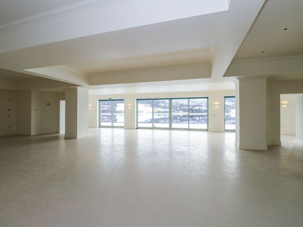 A spacious room with large windows at Schiehallion House in Pitlochry