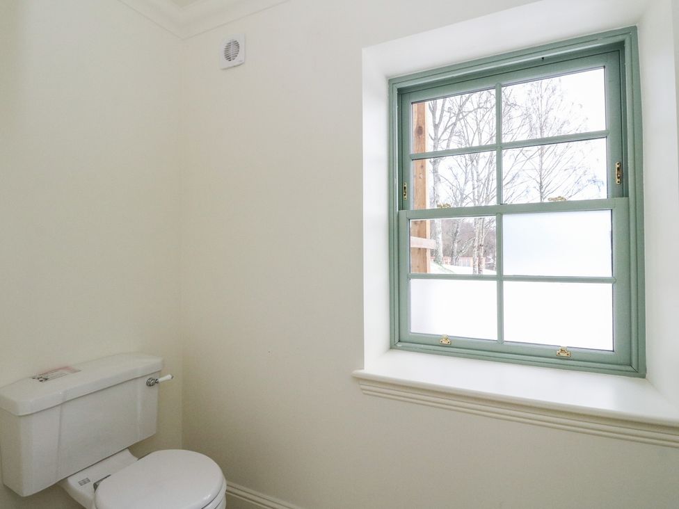 A bathroom with a toilet and a window at Schiehallion House in Pitlochry