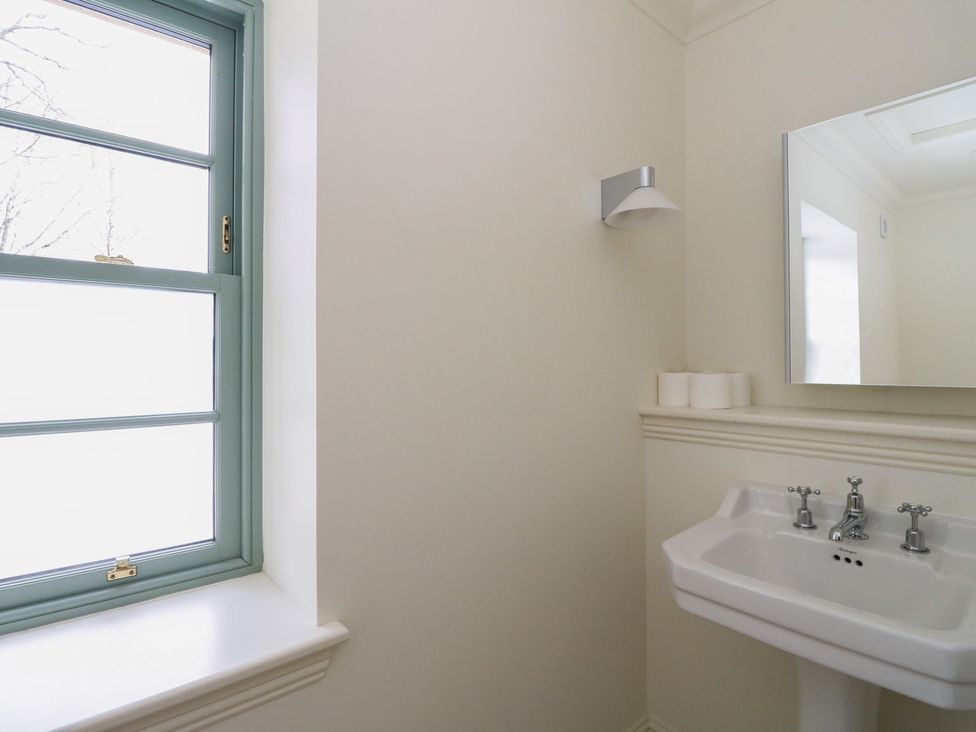 A bathroom with a sink and mirror at Schiehallion House in Pitlochry