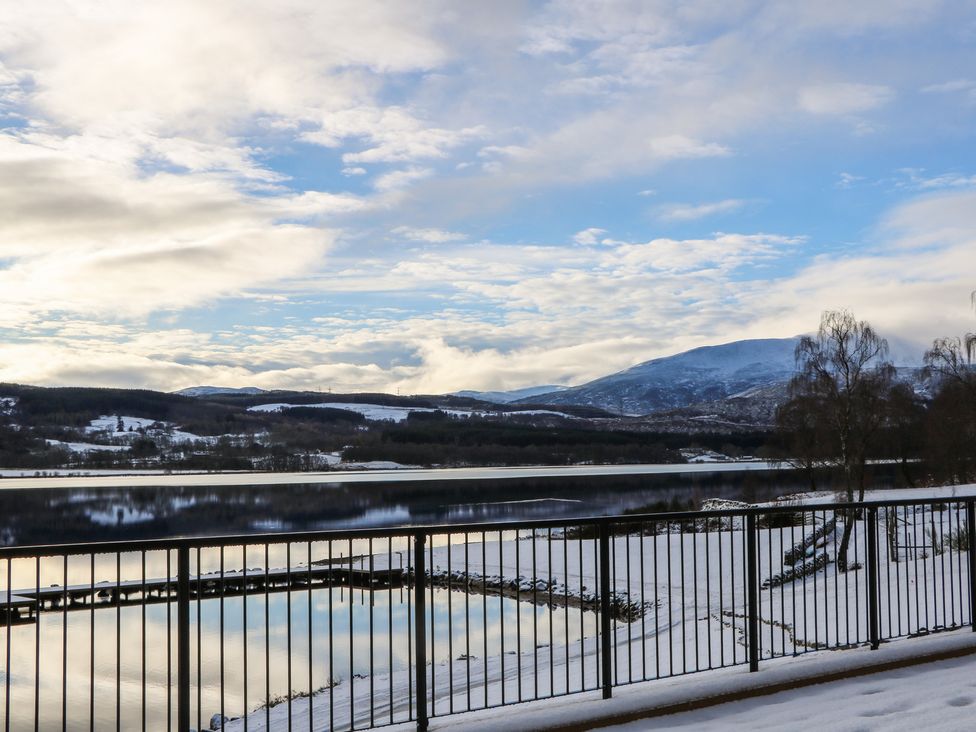 A view of a lake and mountains with snow at Schiehallion House Pitlochry