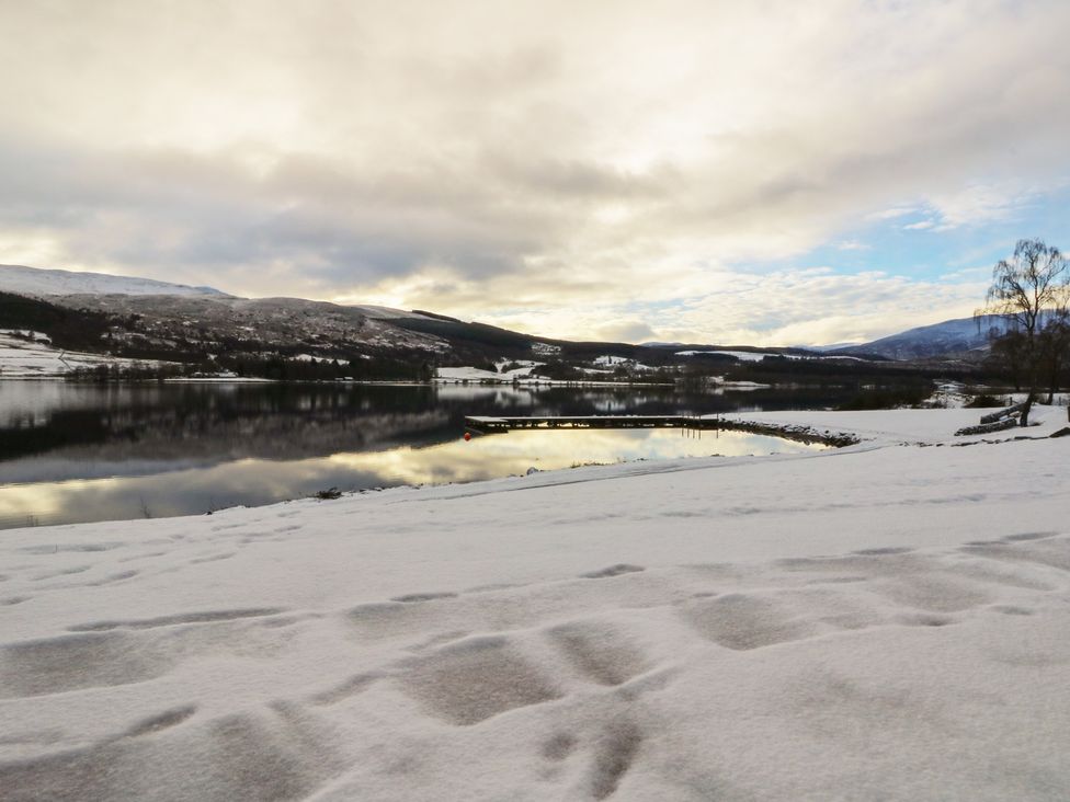 A snowy landscape with a lake and mountains at Schiehallion House in Pitlochry