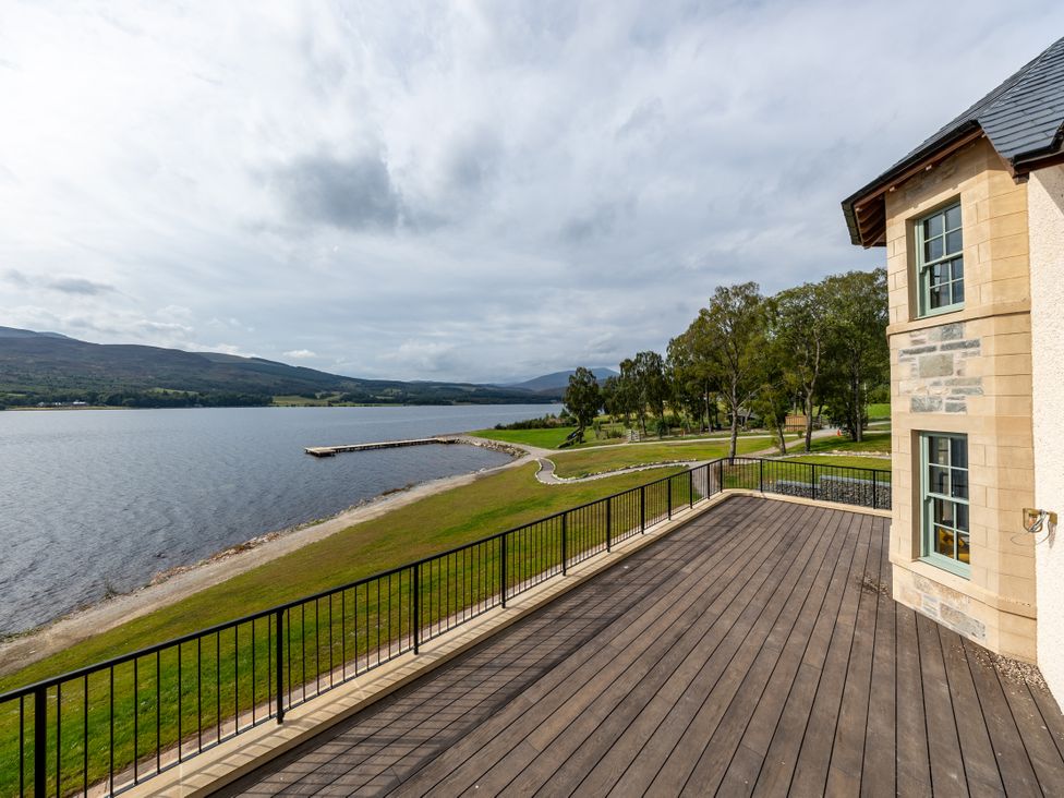 A deck overlooking a lake and landscape at Schiehallion House in Pitlochry