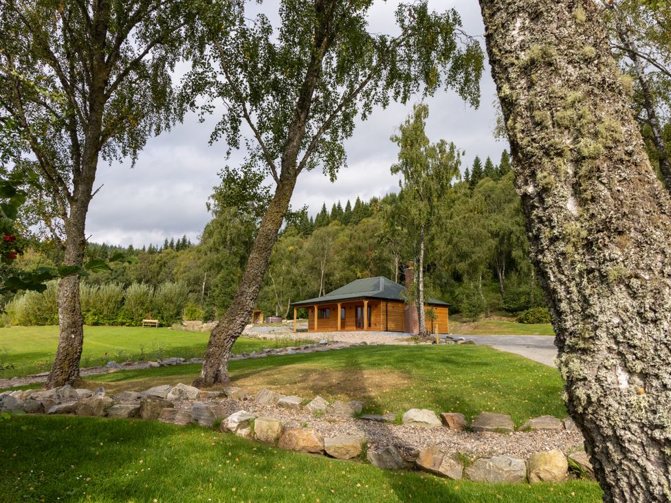 A house surrounded by grass and trees at Schiehallion House Pitlochry