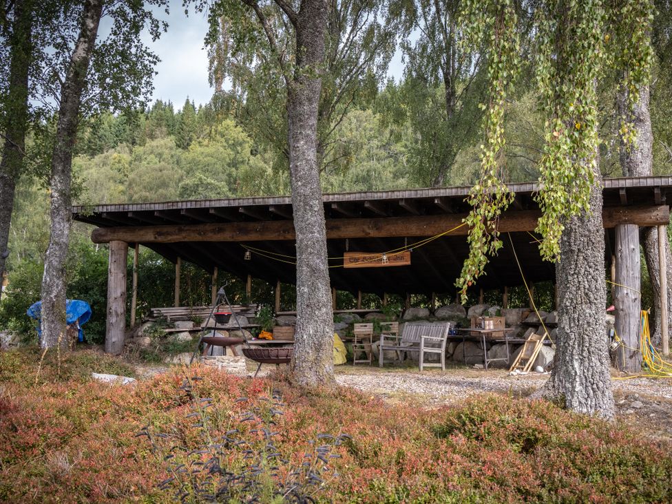 An outdoor shelter with benches and tables at Schiehallion House in Pitlochry