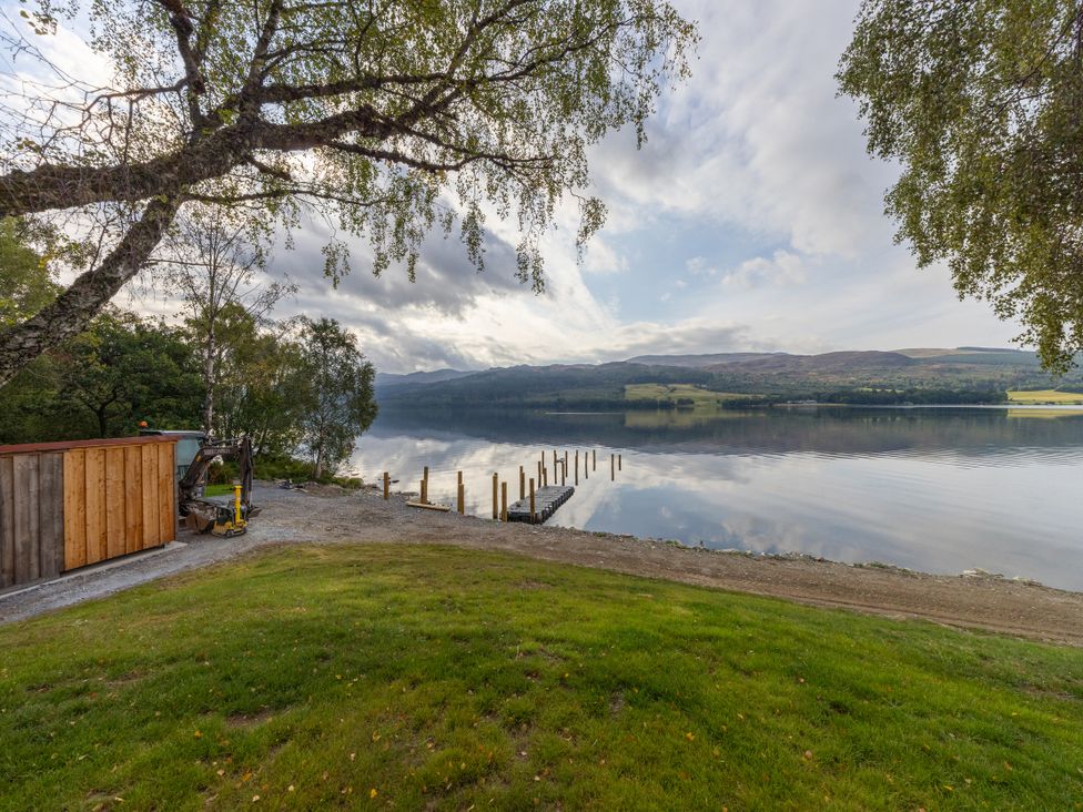 An outdoor area with a lake and dock at Schiehallion House Pitlochry