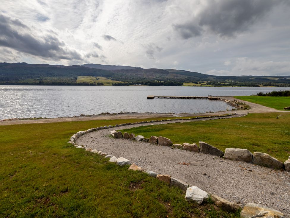 An outdoor area with a lake and a dock at Schiehallion House Pitlochry