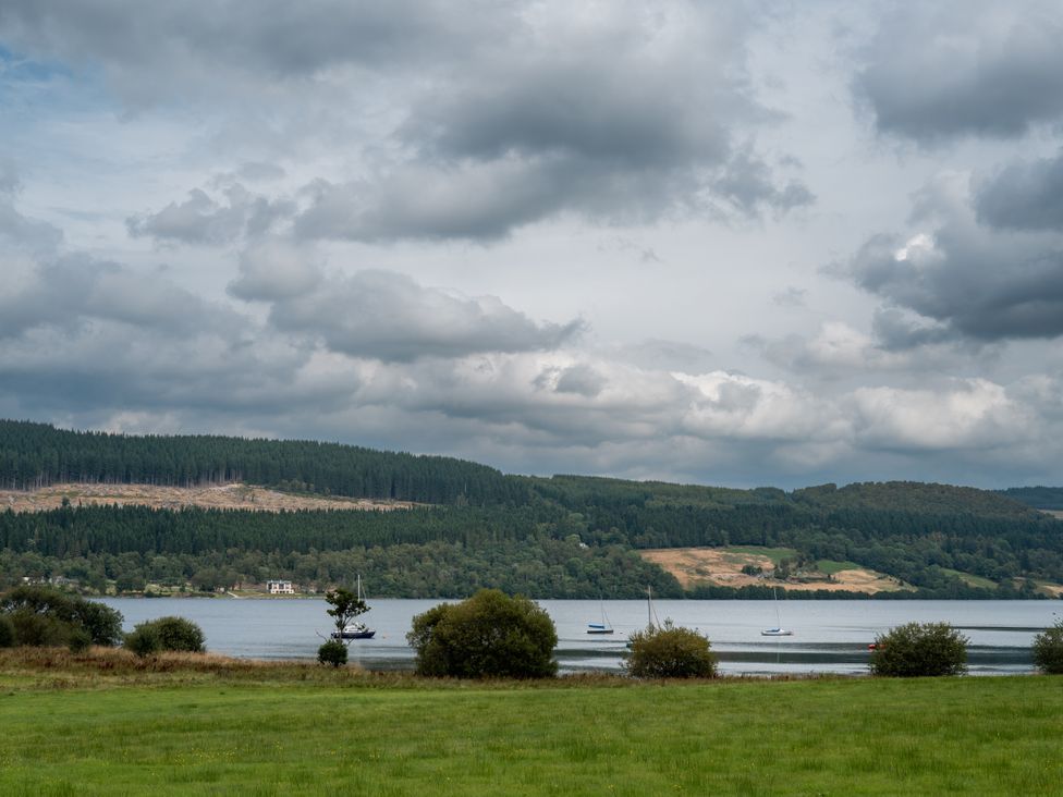 A landscape with a lake and trees at Schiehallion House in Pitlochry