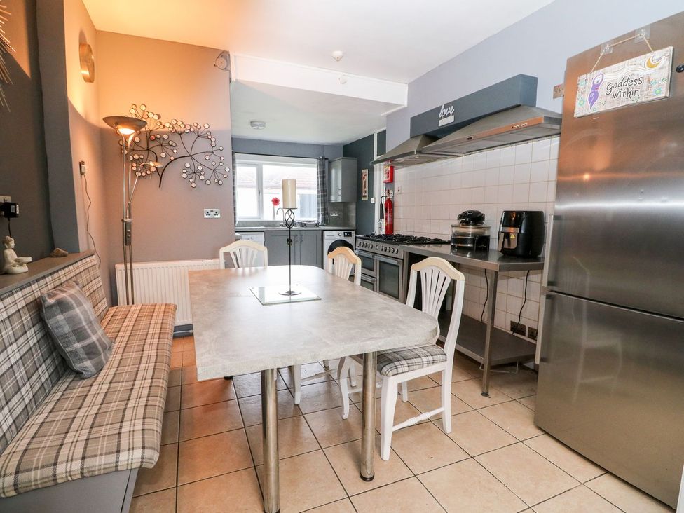 A kitchen with a dining table and chairs at Seaview Wellness Retreat in Carnoustie
