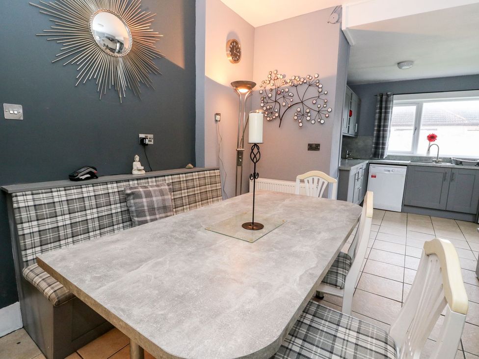 A dining room with a table and seating at Seaview Wellness Retreat in Carnoustie