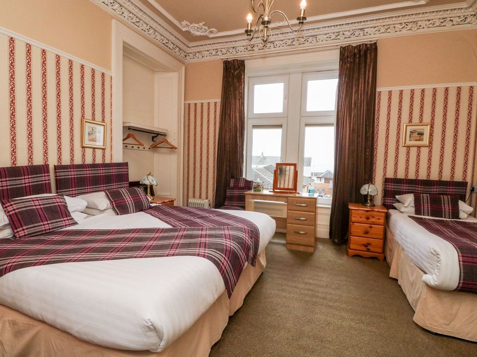 A bedroom with two beds and a window at Seaview Wellness Retreat in Carnoustie