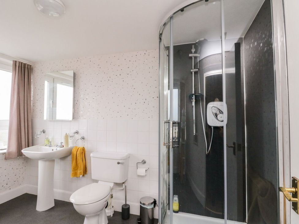 A bathroom with a sink, toilet, and shower at Seaview Wellness Retreat in Carnoustie