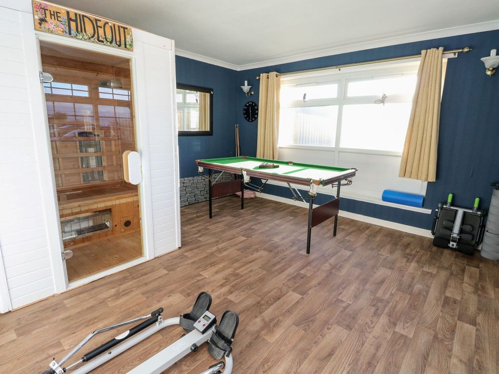 A gym with a sauna, pool table, and exercise equipment at Seaview Wellness Retreat in Carnoustie
