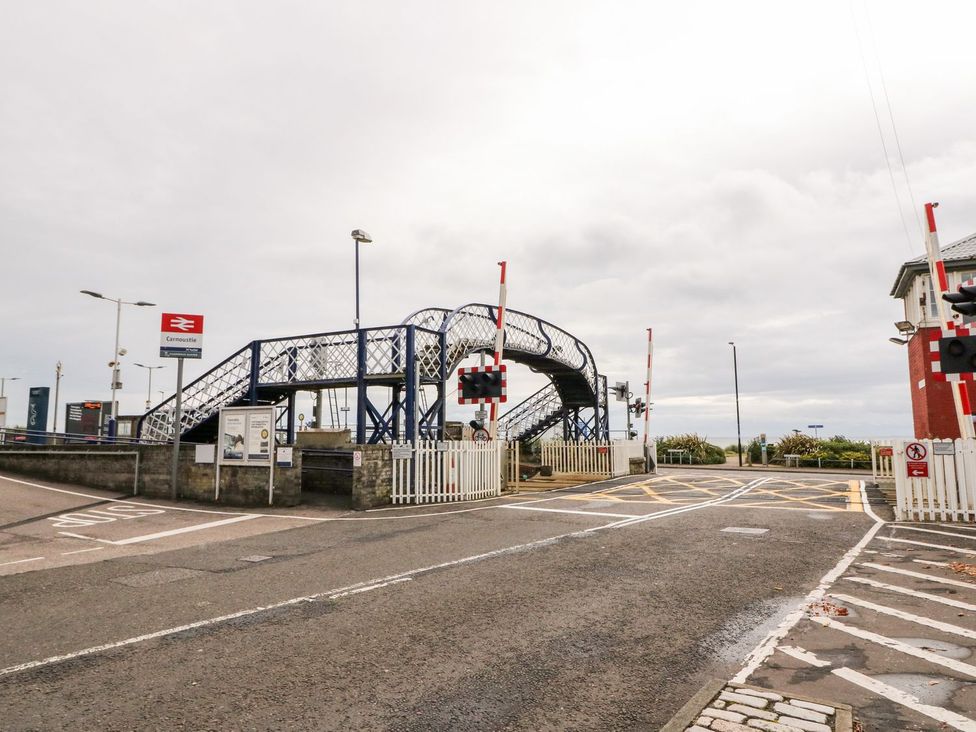 A railway crossing with footbridge and signals at Seaview Wellness Retreat in Carnoustie