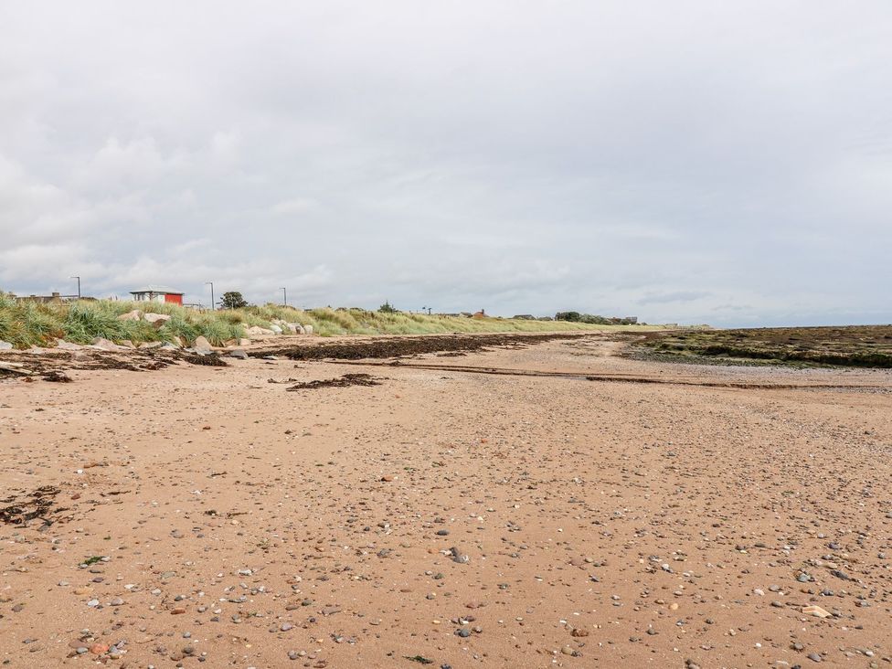 A beach with sand and sea at Seaview Wellness Retreat in Carnoustie