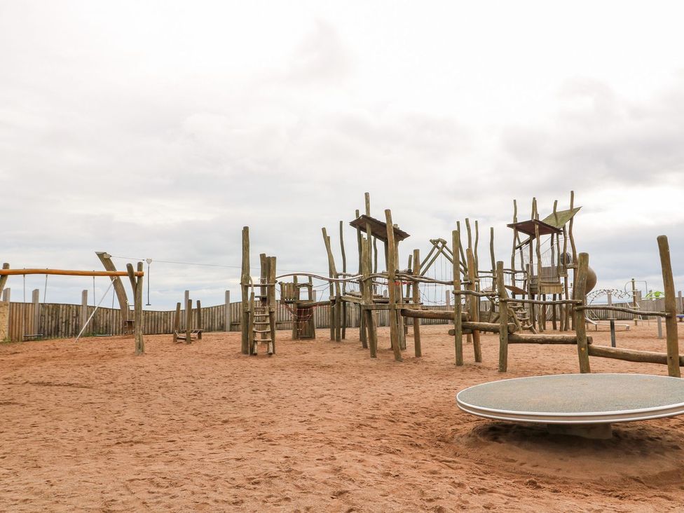 A playground with climbing structures and swings at Seaview Wellness Retreat in Carnoustie