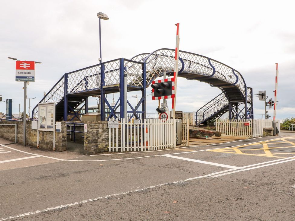 A footbridge and railway signals at Carnoustie railway station