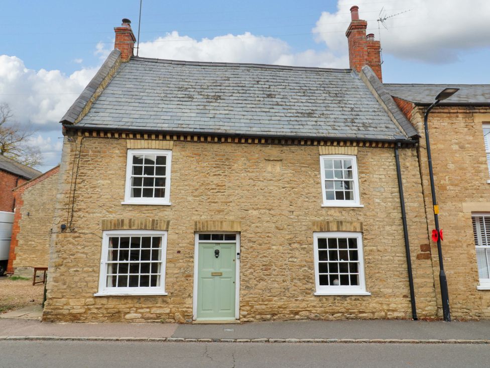 A house with a green door and multiple windows at 118 High Street Bedford