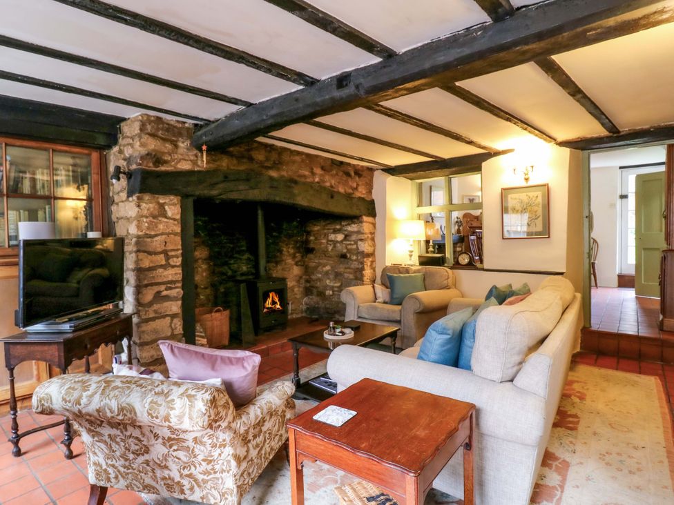 A living room with seating and fireplace at 118 High Street, Bedford