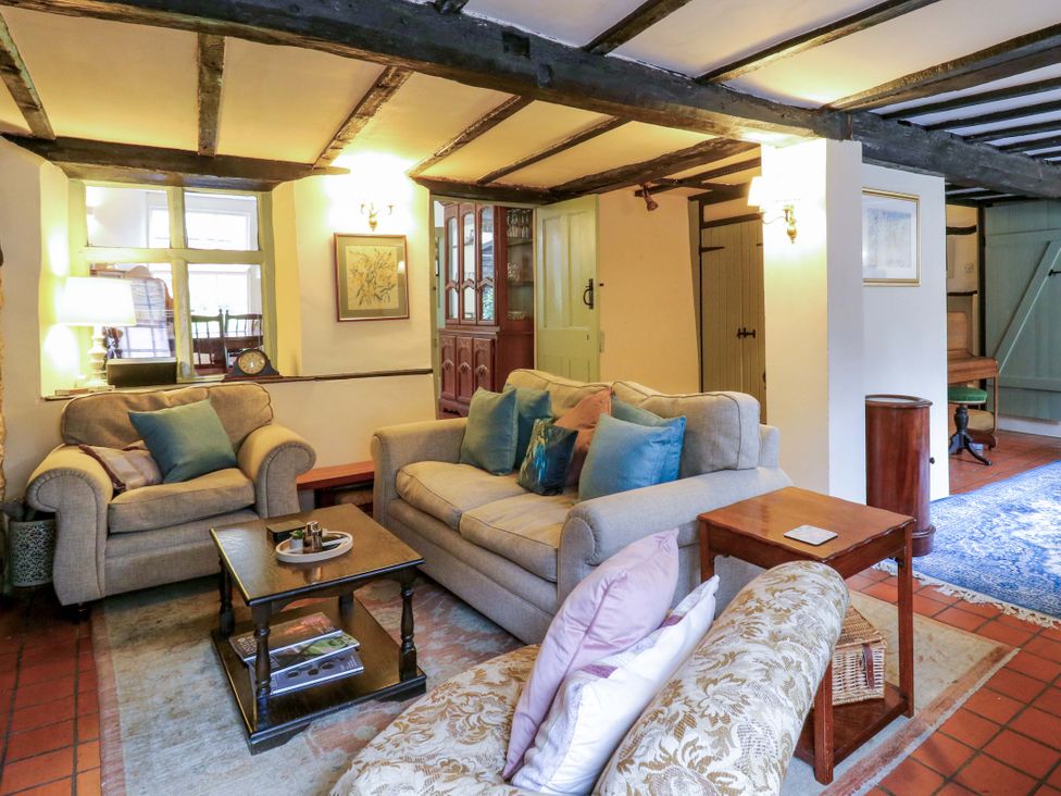 A living room with a sofa and armchair at 118 High Street, Bedford