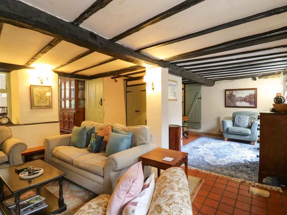 A living room with a sofa and armchair at 118 High Street Bedford