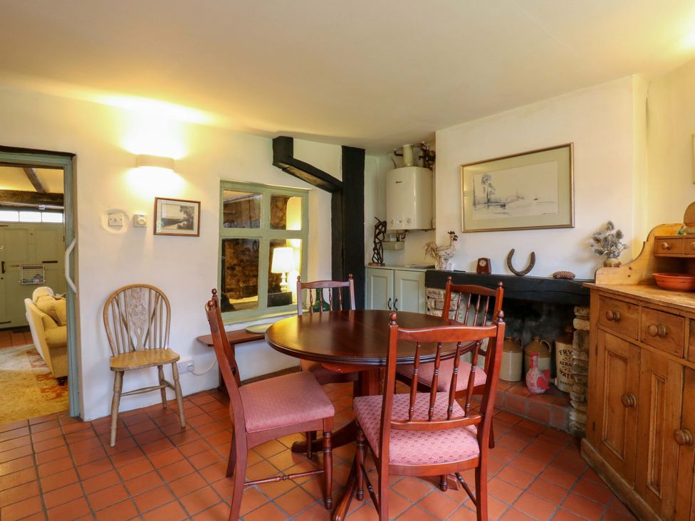 A dining room with a table and chairs at 118 High Street in Bedford