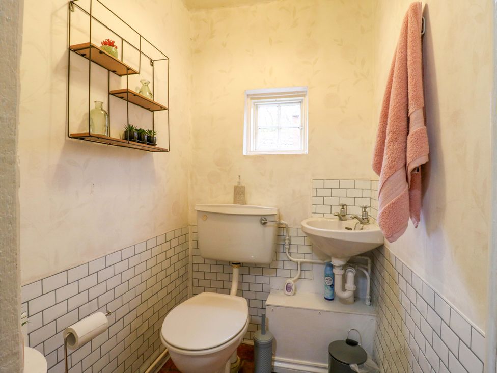 A bathroom with a toilet and sink at 118 High Street in Bedford