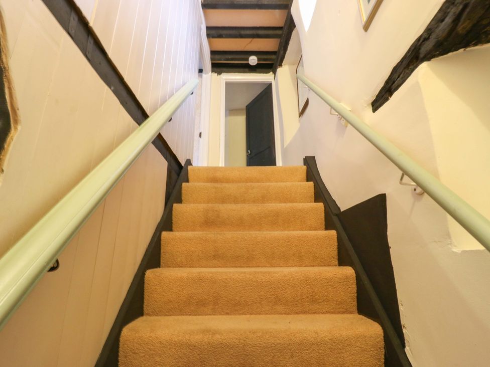 A staircase leading to a door at 118 High Street, Bedford