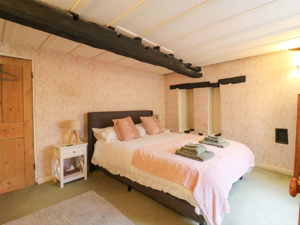 A bedroom with a bed and bedside table at 118 High Street in Bedford