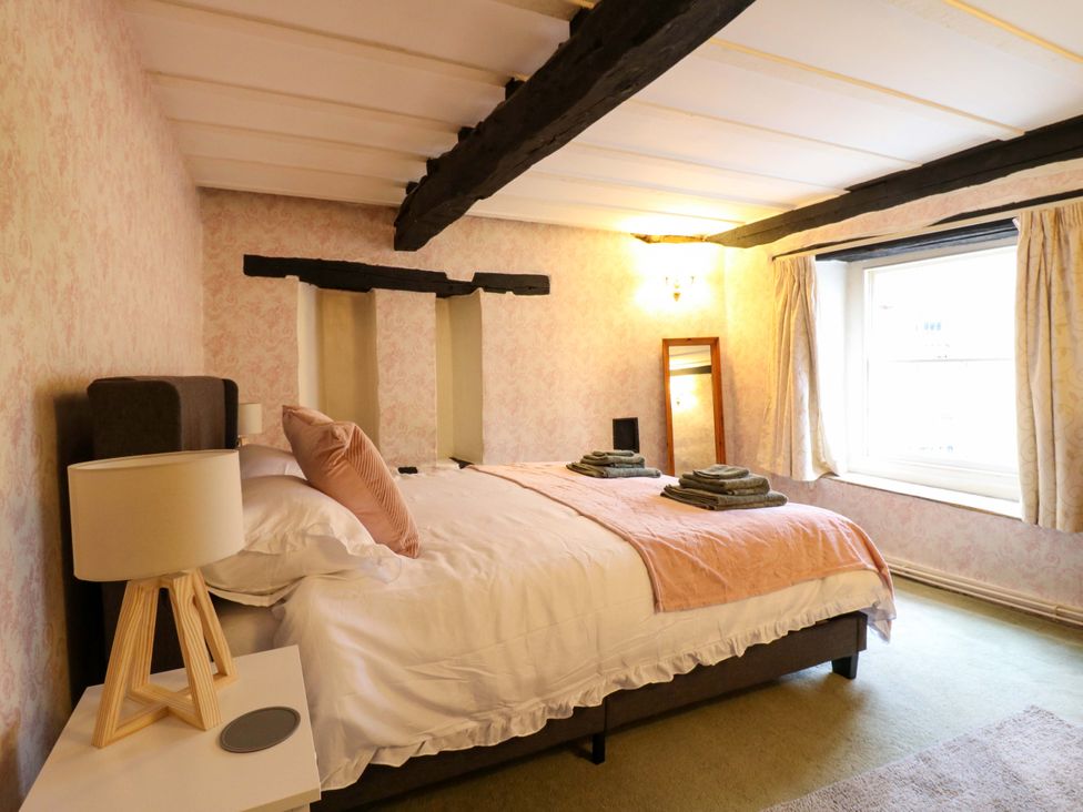 A bedroom with a bed and towels at 118 High Street Bedford