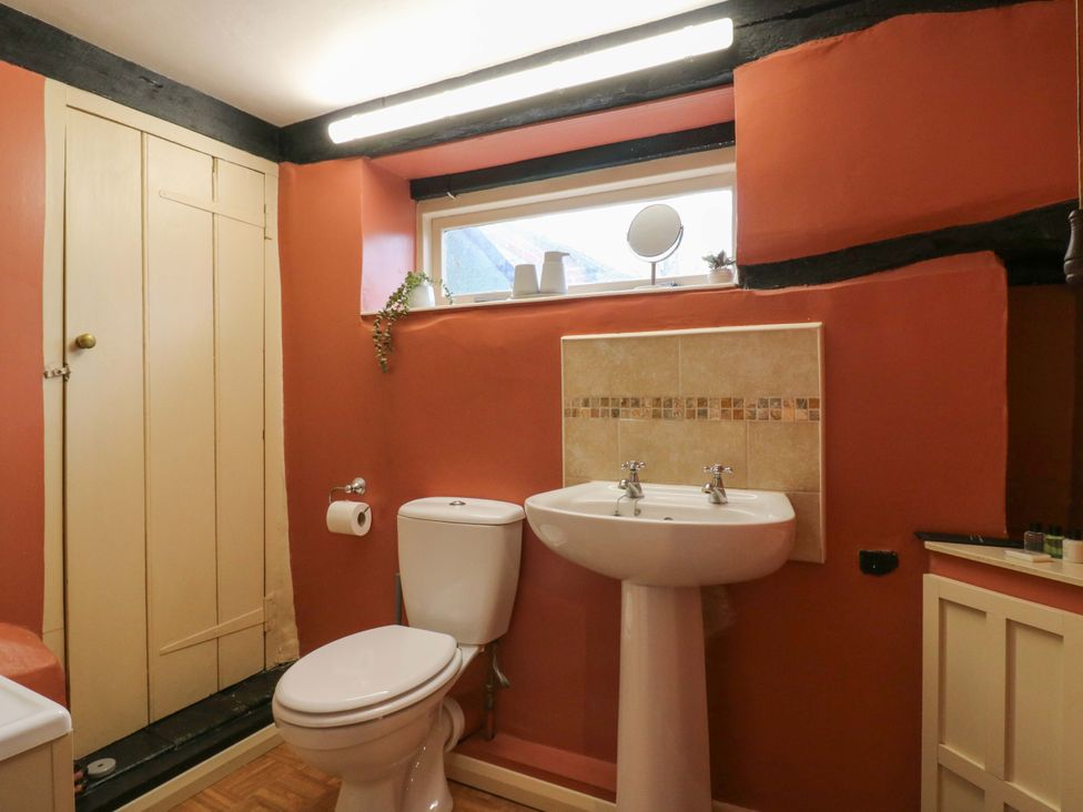 A bathroom with toilet and sink at 118 High Street Bedford