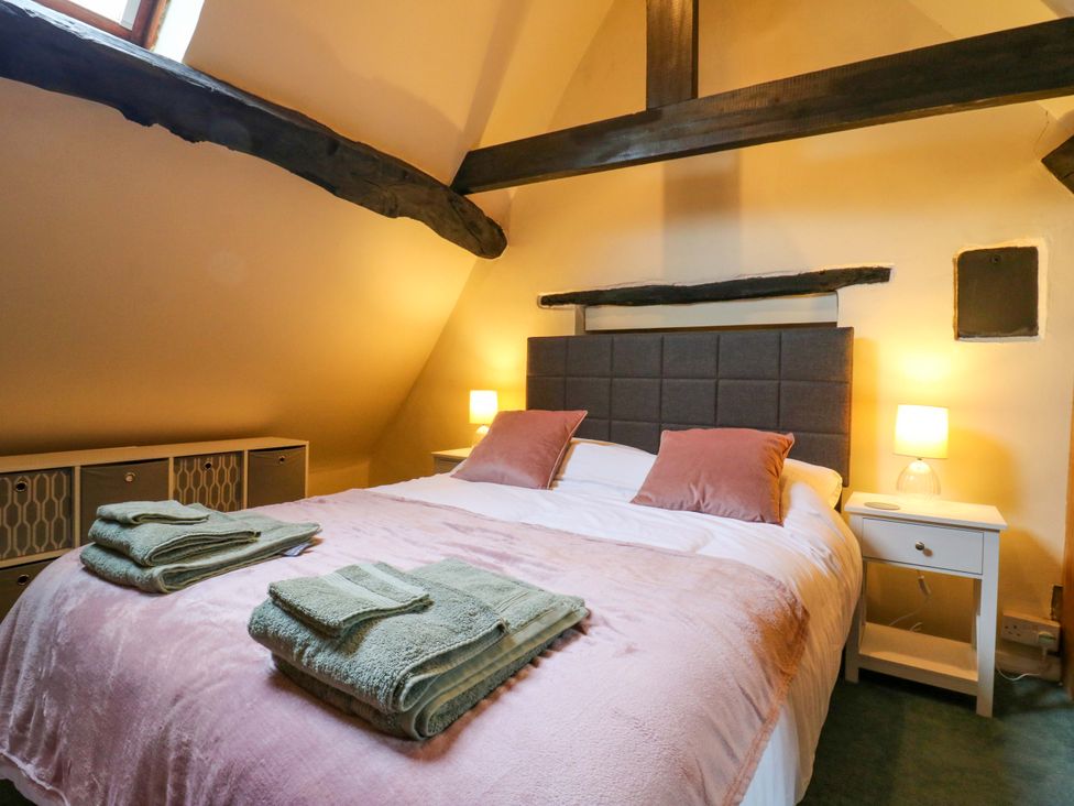 A bedroom with a bed and bedside table at 118 High Street in Bedford