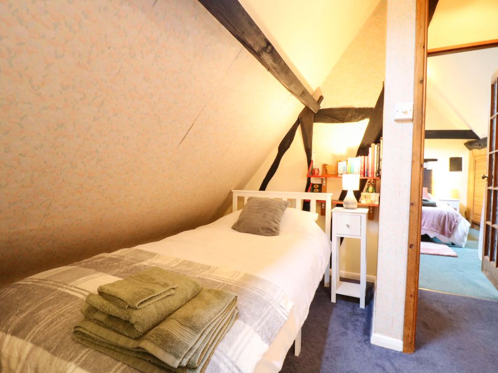 A bedroom with a single bed and a nightstand at 118 High Street in Bedford