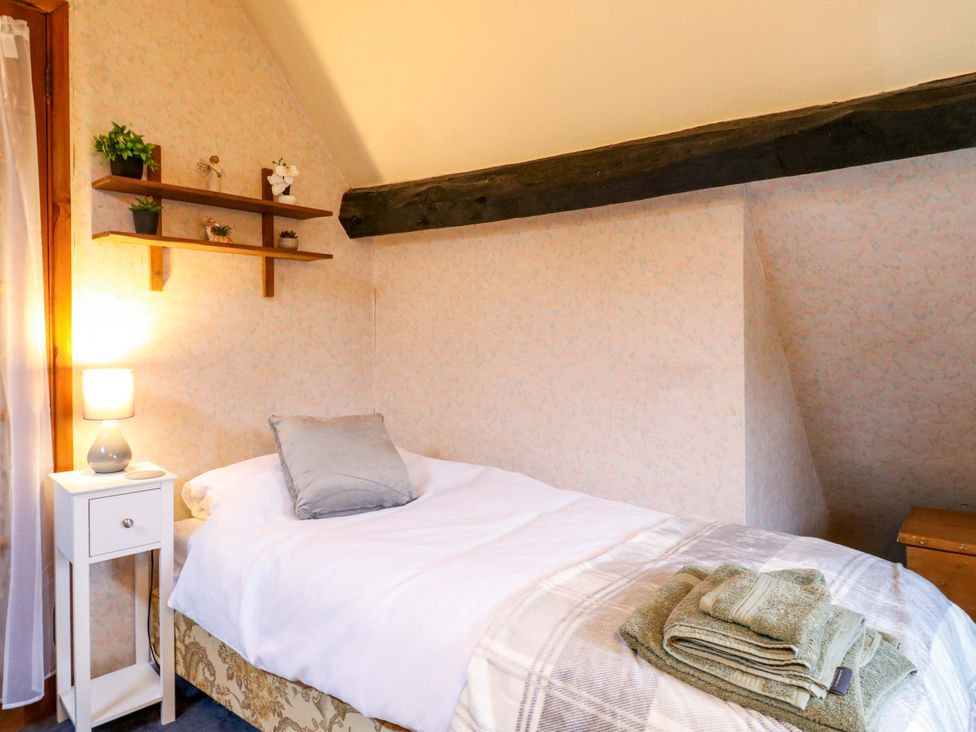 A bedroom with a bed and shelf at 118 High Street in Bedford