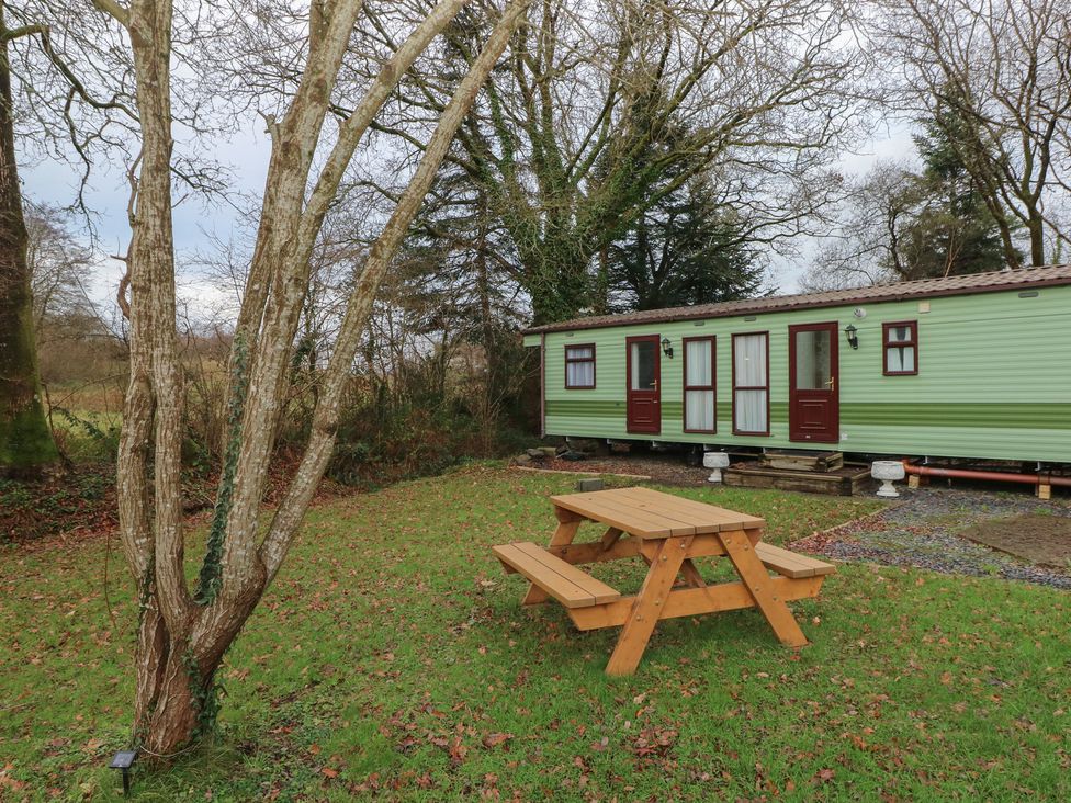 An outdoor area with a picnic table near a static caravan at Static Caravan in 